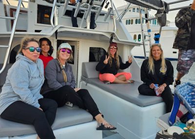 women sitting on the ole ole fishing boat in cabo marina