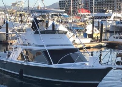 ole ole fishing boat heading out of harbor in cabo