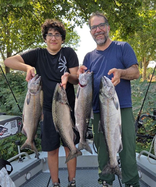 father son show off large salmon caught on the Clearwater River